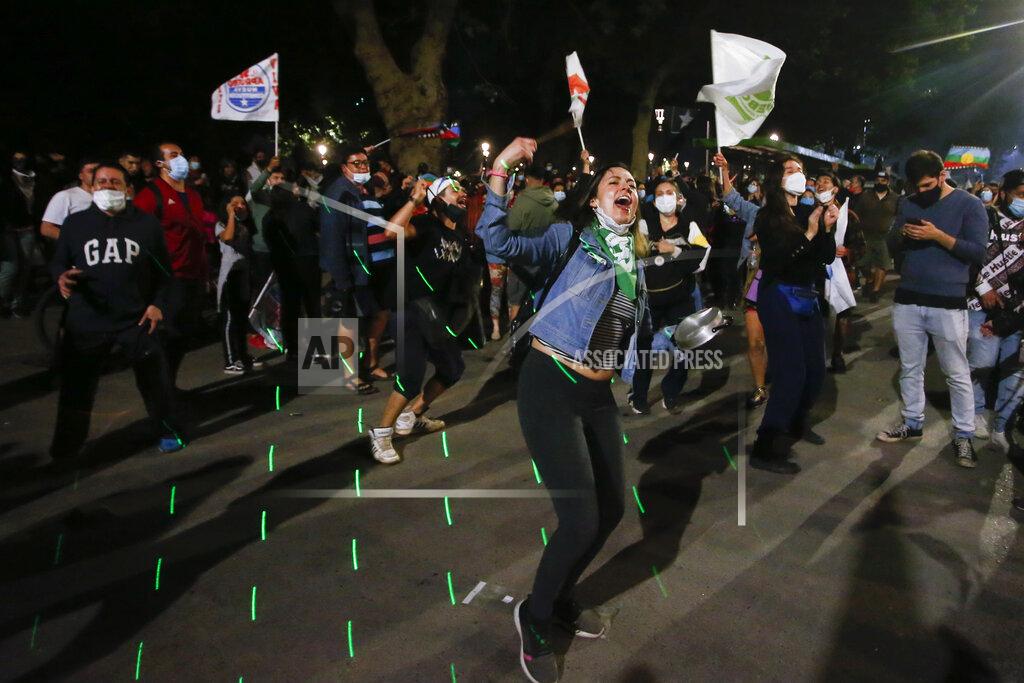 Luis Hidalgo People gather at Plaza Italia on the day Chileans voted in a referendum to decide whether the country should replace its 40-year-old constitution, written during the dictatorship of Gen. Augusto Pinochet, in Santiago, Chile, Sunday, Oct. 25, 2020. (AP Photo/Luis Hidalgo)