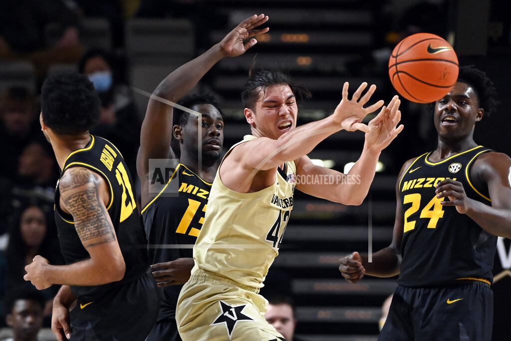 Mark Zaleski Vanderbilt forward Quentin Millora-Brown (42) passes the ball as he is defended by Missouri guard Kaleb Brown (13) and forward Ronnie DeGray III (21) during the second half of an NCAA college basketball game Tuesday, Feb. 8, 2022, in Nashville, Tenn. Vanderbilt won 70-62. (AP Photo/Mark Zaleski)