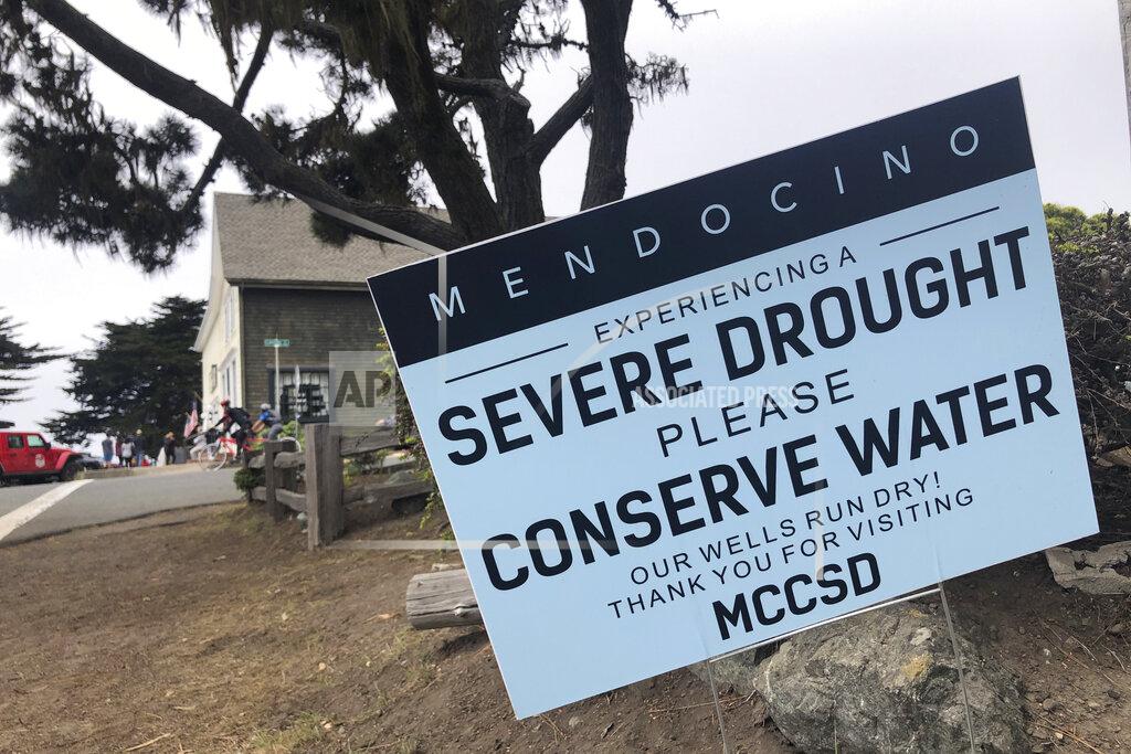 Haven Daley FILE— Signs alert visitors to the severe drought in Mendocino, Calif., on Wednesday, Aug. 4, 2021. California Gov. Gavin Newsom threatened Monday, May 23, 2022, to impose mandatory, statewide restrictions on water use if people don't start using less on their own as the drought drags on and the hotter summer months approach. (AP Photo/Haven Daley, File)