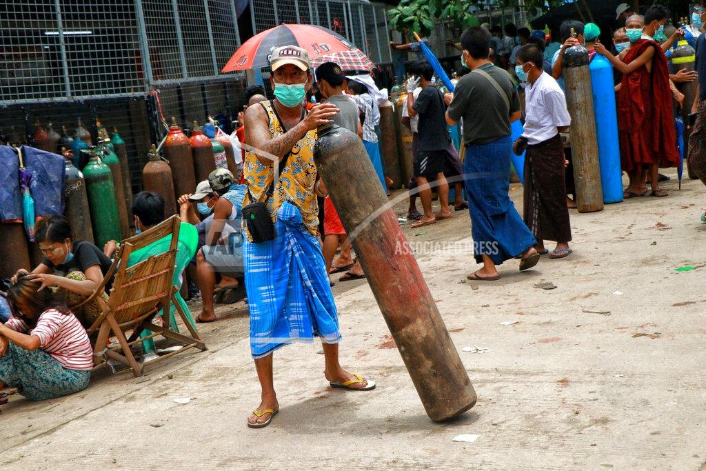 Uncredited A man holds an oxygen tank while waiting outside the Naing oxygen factory at the South Dagon industrial zone in Yangon, Myanmar, Wednesday, July 28, 2021. Myanmar is currently reeling from soaring numbers of COVID-19 cases and deaths that are badly straining the country’s medical infrastructure. (AP Photo)
