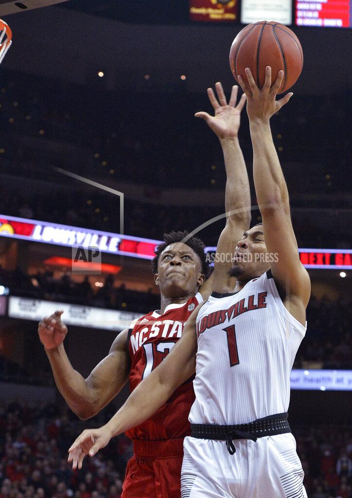 Timothy D. Easley North Carolina State guard C.J. Bryce (13) defends against a shot by Louisville guard Christen Cunningham (1) during the second half of an NCAA college basketball game in Louisville, Ky., Thursday, Jan. 24, 2019. Louisville won 84-77. (AP Photo/Timothy D. Easley)