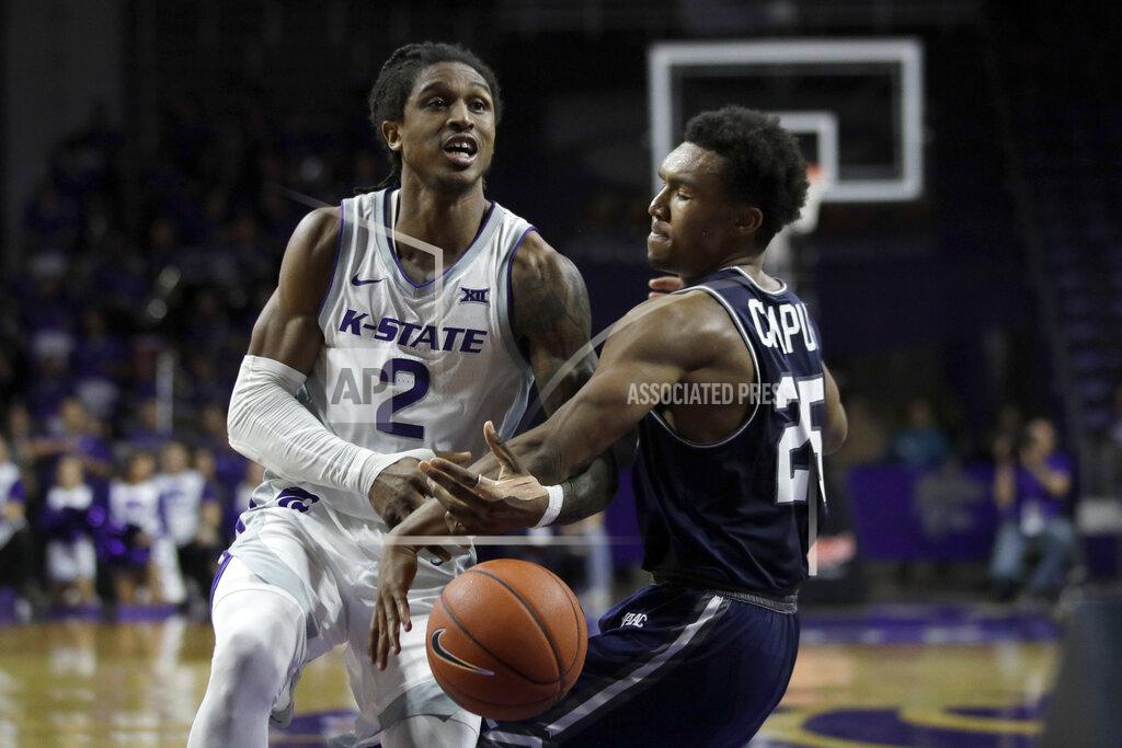 Orlin Wagner Monmouth guard Samuel Chaput (25) knocks the ball away from Kansas State guard Cartier Diarra (2) during the second half of an NCAA college basketball game in Manhattan, Kan., Wednesday, Nov. 13, 2019. (AP Photo/Orlin Wagner)