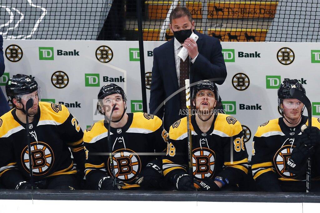 Michael Dwyer Boston Bruins head coach Bruce Cassidy stands behind his team as they look up at the scoreboard after a goal by Washington Capitals' Conor Sheary during the second period of an NHL hockey game, Sunday, April 11, 2021, in Boston. (AP Photo/Michael Dwyer)