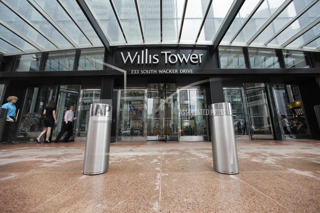 M. Spencer Green FILE - This Aug. 23, 2011, file photo, shows one of the entrances to the Willis Tower in Chicago. Shares of Aon are climbing for a second straight day after the benefits and risk consultant company and rival Willis Towers Watson decided to end their $30 billion all-stock takeover deal. Aon announced the agreement in March 2020, but last month the Justice Department sued to block it. The department asserted the deal could eliminate competition, raise prices and hamper innovation for U.S. businesses, employers and unions that use the companies’ services. (AP Photo/M. Spencer Green, File)