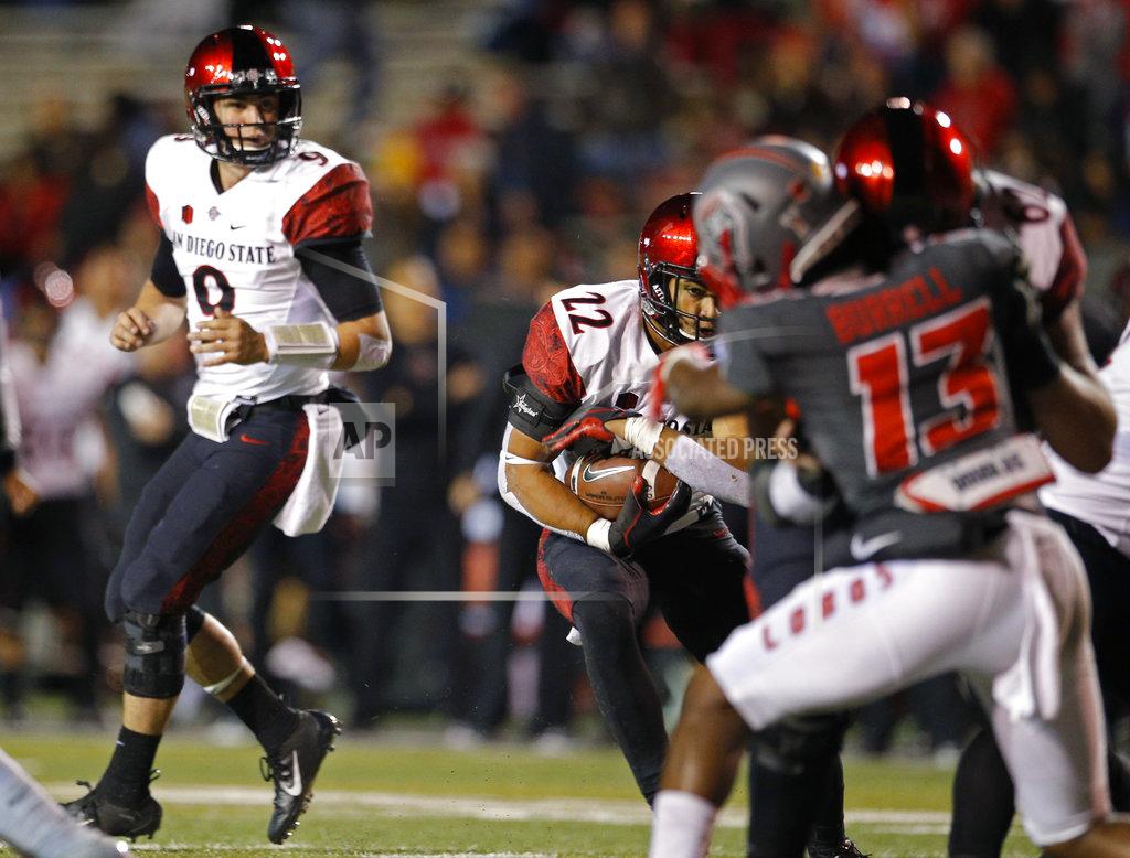 Andres Leighton San Diego State running back Chase Jasmin (22) tries to get through the New Mexico defense after taking a handoff from quarterback Ryan Agnew (9) during the first half of an NCAA college football game in Albuquerque, N.M., Saturday, Nov. 3, 2018. (AP Photo/Andres Leighton)