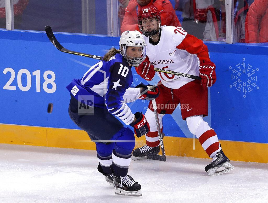 Frank Franklin Ii FILE - In this Feb. 13, 2018, file photo, Meghan Duggan (10), of the United States, and Yekaterina Nikolayeva (76), of Russia, chase the puck during the first period of the preliminary round of the women's hockey game at the Winter Olympics in Gangneung, South Korea. U.S. women's hockey captain Duggan announced her retirement Tuesday, Oct. 13, 2020, after a career in which she won the 2018 Olympic gold medal and seven world championship golds. (AP Photo/Frank Franklin II, File)