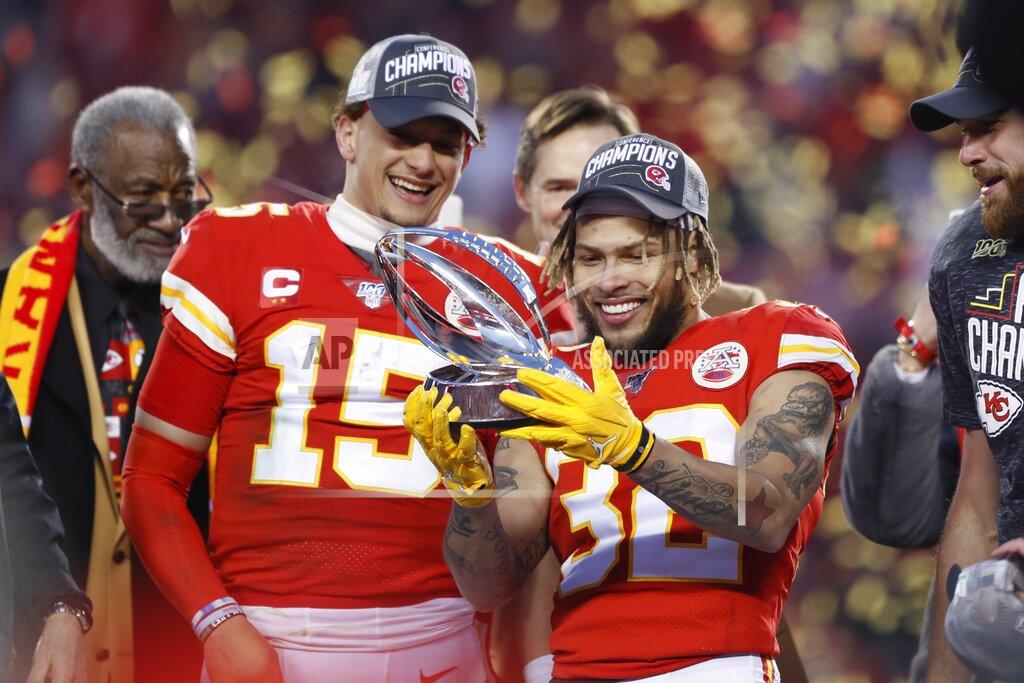 Charlie Neibergall Kansas City Chiefs' Tyrann Mathieu and Patrick Mahomes (15) hold up the Lamar Hunt Trophy after the NFL AFC Championship football game against the Tennessee Titans Sunday, Jan. 19, 2020, in Kansas City, MO. The Chiefs won 35-24 to advance to Super Bowl 54. (AP Photo/Charlie Neibergall)