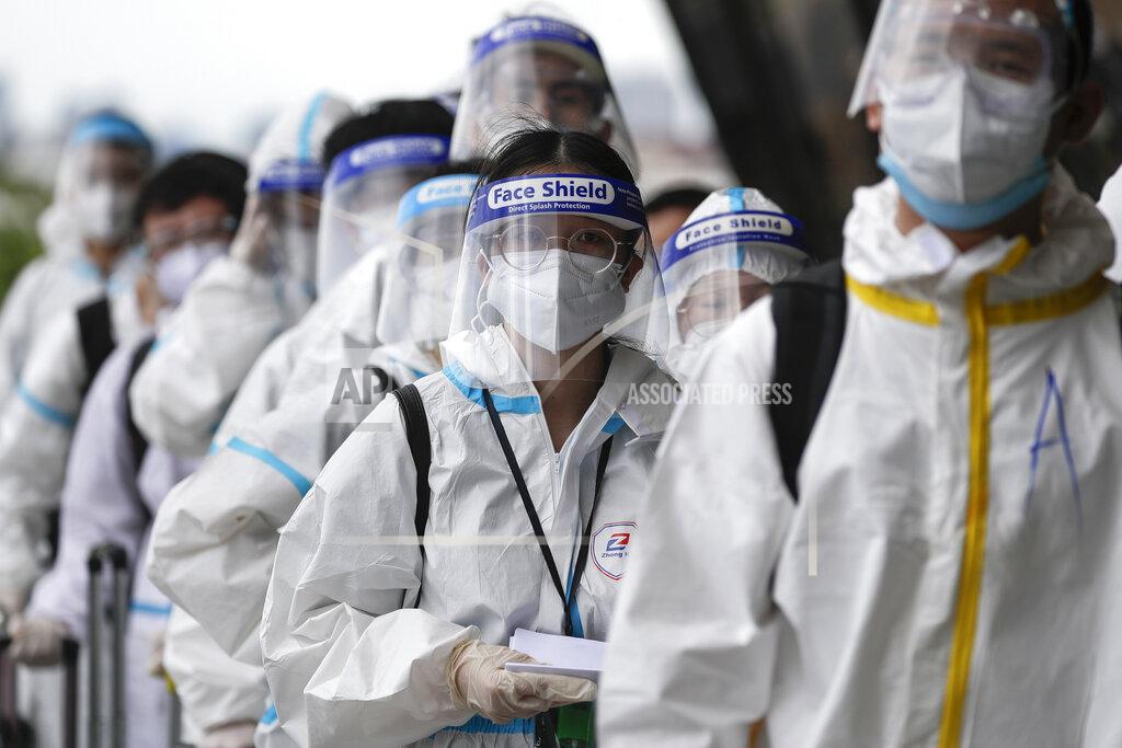 Aaron Favila Foreign passengers wearing protective suits line up for their flight to China at Manila's International Airport, Philippines, Monday, Jan. 18, 2021. Coronavirus infections in the Philippines have surged past 500,000 in a new bleak milestone with the government facing criticisms for failing to immediately launch a vaccination program amid a global scramble for COVID-19 vaccines. (AP Photo/Aaron Favila)