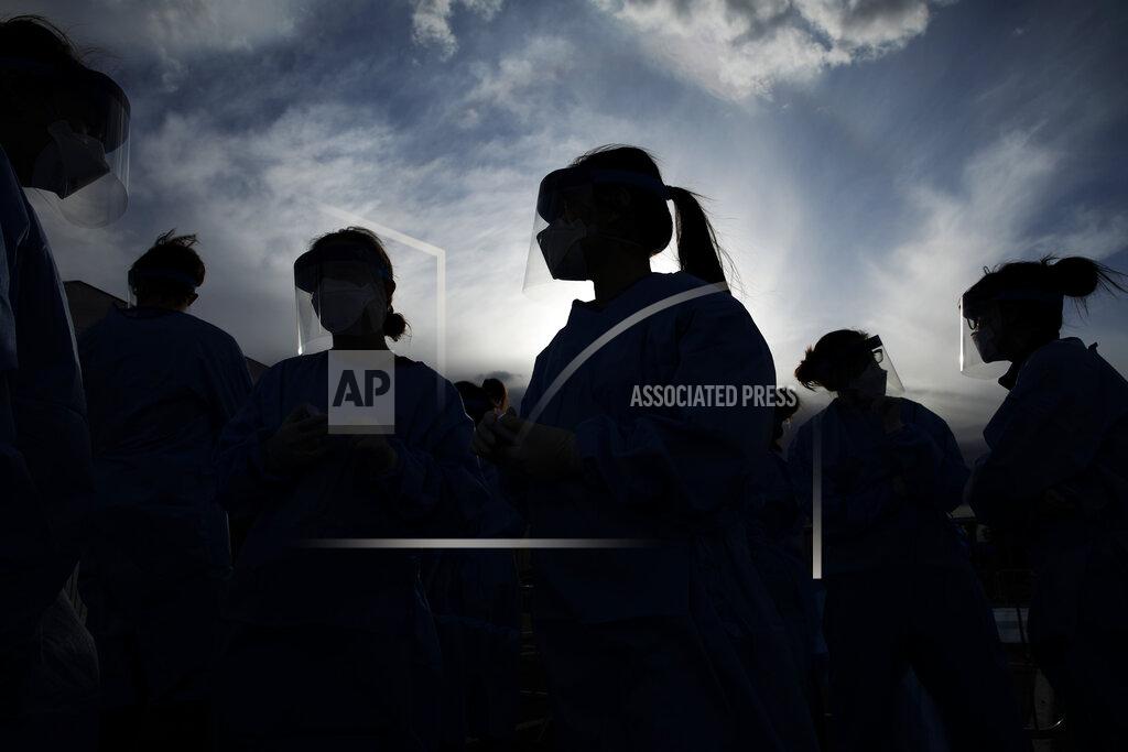 John Locher FILE - In this March 28, 2020, file photo, medical and physician assistant students wear personal protective equipment as they prepare to screen for possible coronavirus cases at a makeshift camp for the homeless in Las Vegas. The U.S. death toll from the coronavirus topped 200,000 Tuesday, Sept. 22, a figure unimaginable eight months ago when the scourge first reached the world’s richest nation with its sparkling laboratories, top-flight scientists and towering stockpiles of medicines and emergency supplies. (AP Photo/John Locher, File)