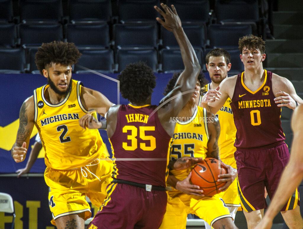 Tony Ding Minnesota forward Isaiah Ihnen (35) collides with Michigan guard Eli Brooks (55) in the second half of an NCAA college basketball game at Crisler Center in Ann Arbor, Mich., Wednesday, Jan. 6, 2021. Brooks lost a tooth from the impact and left the game. (AP Photo/Tony Ding)