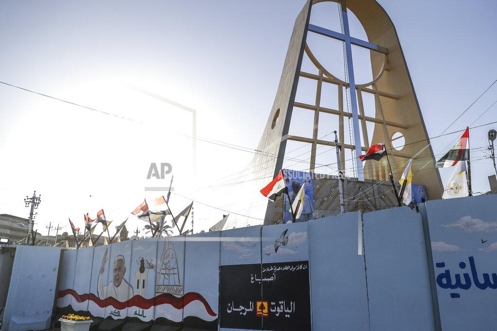 Andrew Medichini A mural depicting Pope Francis is seen in Baghdad, Iraq, Friday, March 5, 2021. Pope Francis has arrived in Iraq to urge the country's dwindling number of Christians to stay put and help rebuild the country after years of war and persecution, brushing aside the coronavirus pandemic and security concerns. (AP Photo/Andrew Medichini)
