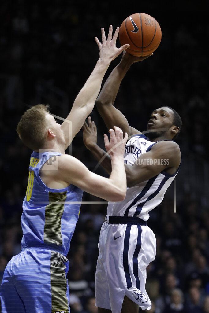 Darron Cummings Butler's Kamar Baldwin (3) shoot over Marquette's Sam Hauser (10) during the first half of an NCAA college basketball game, Wednesday, Jan. 30, 2019, in Indianapolis. (AP Photo/Darron Cummings)