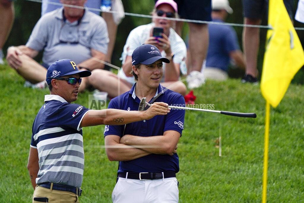 Darron Cummings Rickie Fowler, left, talks with Carlos Ortiz, of Mexico, on the 10th green during the third round of the Memorial golf tournament, Saturday, June 5, 2021, in Dublin, Ohio. (AP Photo/Darron Cummings)