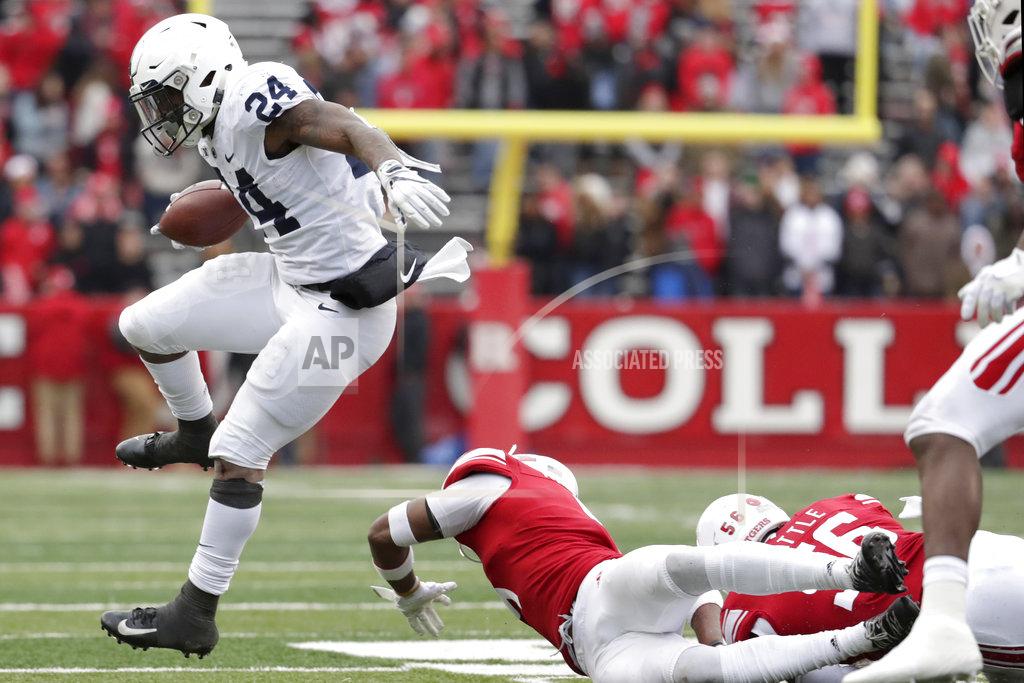 Julio Cortez Penn State running back Miles Sanders, left, leaps over Rutgers defenders during the second half of an NCAA college football game, Saturday, Nov. 17, 2018, in Piscataway, N.J. Penn State won 20-7. (AP Photo/Julio Cortez)