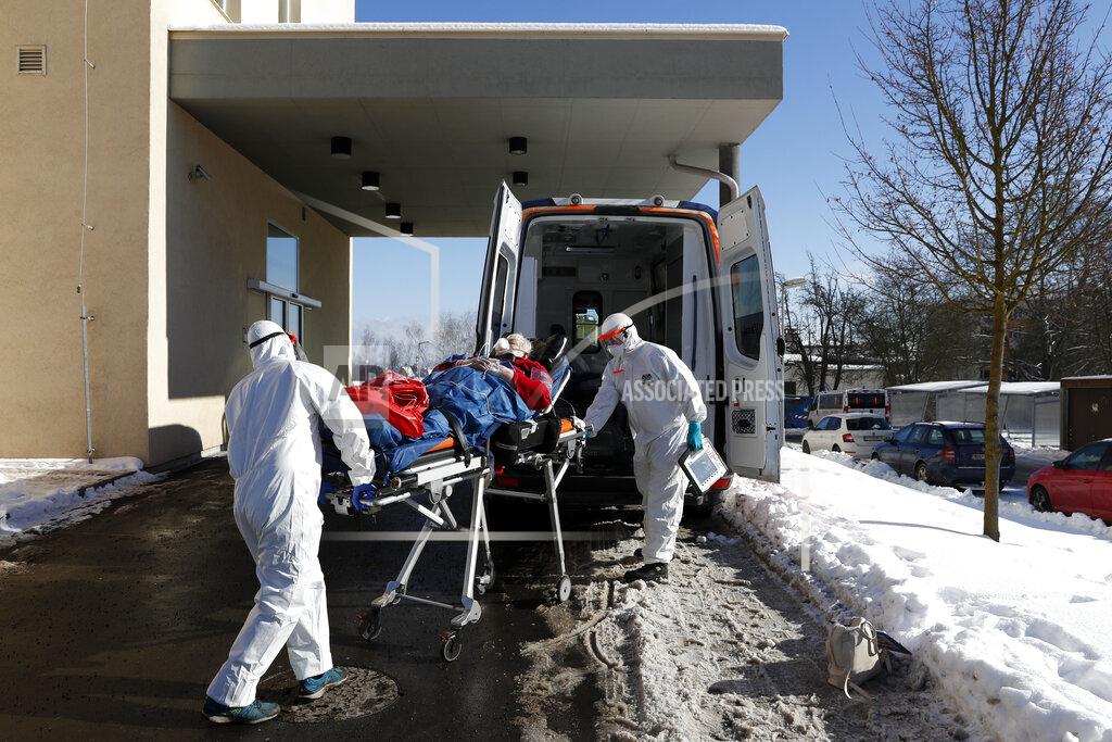 Petr David Josek FILE - In this Friday, Feb. 12, 2021, file photo, medical workers move a covid-19 patient into an ambulance at a hospital overrun by the covid pandemic in Cheb, Czech Republic. The Czech government has decided to further tighten restrictive measures amid a surge of a highly contagious coronavirus variant in one of the hardest-hit European Union's nations. At the same time, the worsening situation has forced the Cabinet to abandon for now its plans to reopen all stores as soon as next week. (AP Photo/Petr David Josek/File)