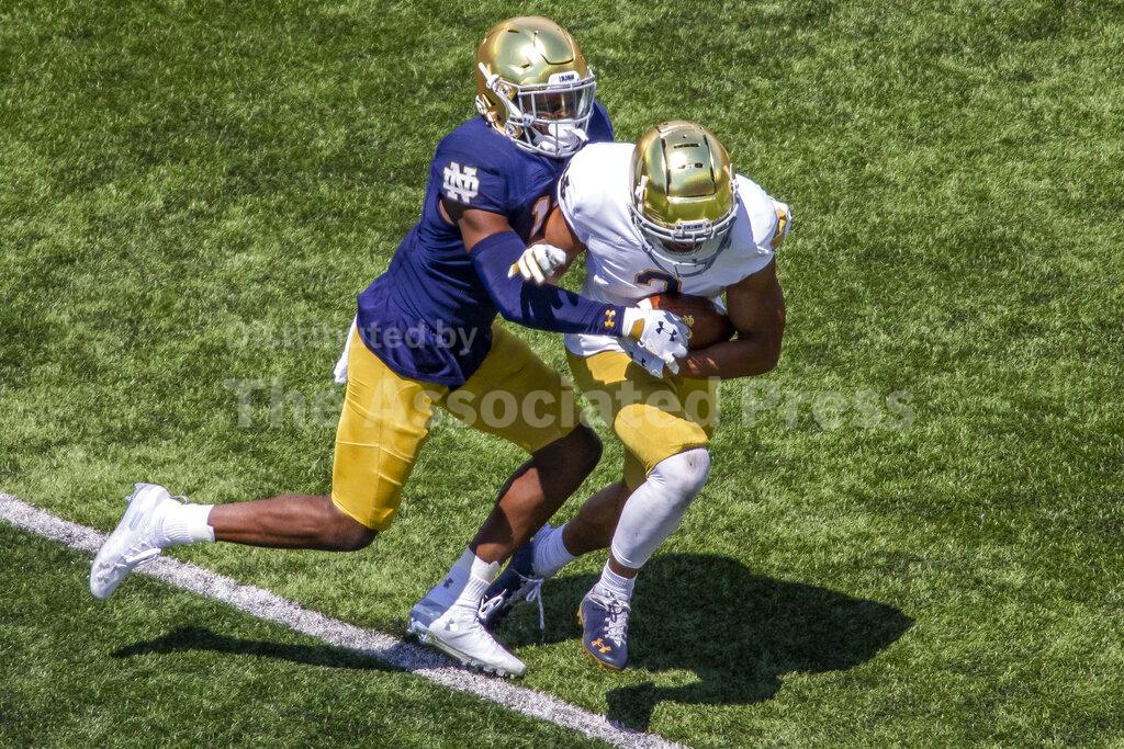 Notre Dame safety DJ Brown, left, brings down wide receiver Avery Davis, right, during the Blue-Gold NCAA spring football game on Saturday, May 1, 2021, in South Bend, Ind. (AP Photo/Robert Franklin)