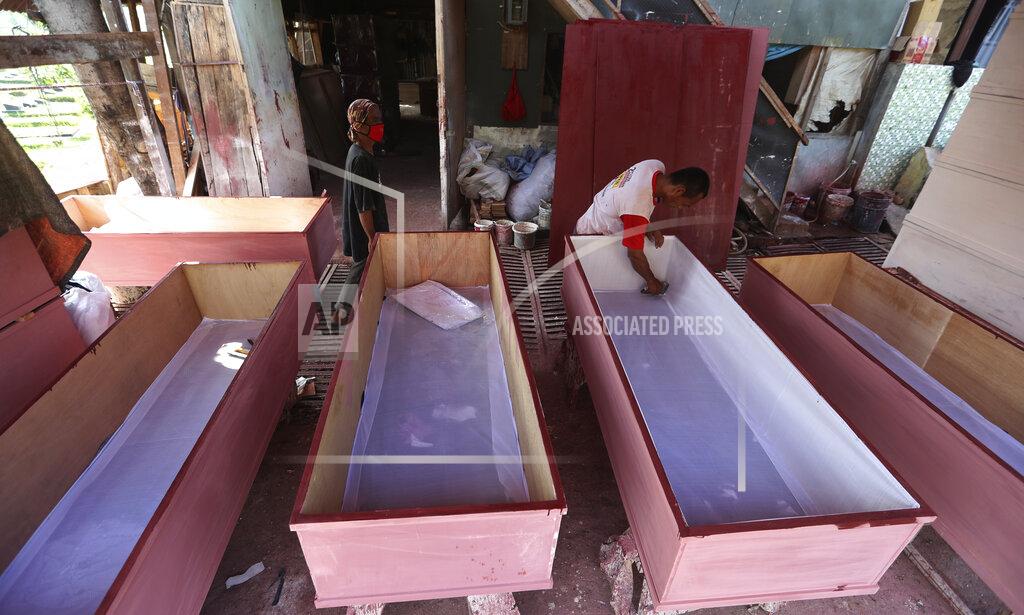 Achmad Ibrahim Workers make coffins to be used for victims of the coronavirus in Jakarta, Indonesia, Tuesday, July 27, 2021. Indonesia has been showing sharp increases since late June. (AP Photo/Achmad Ibrahim)