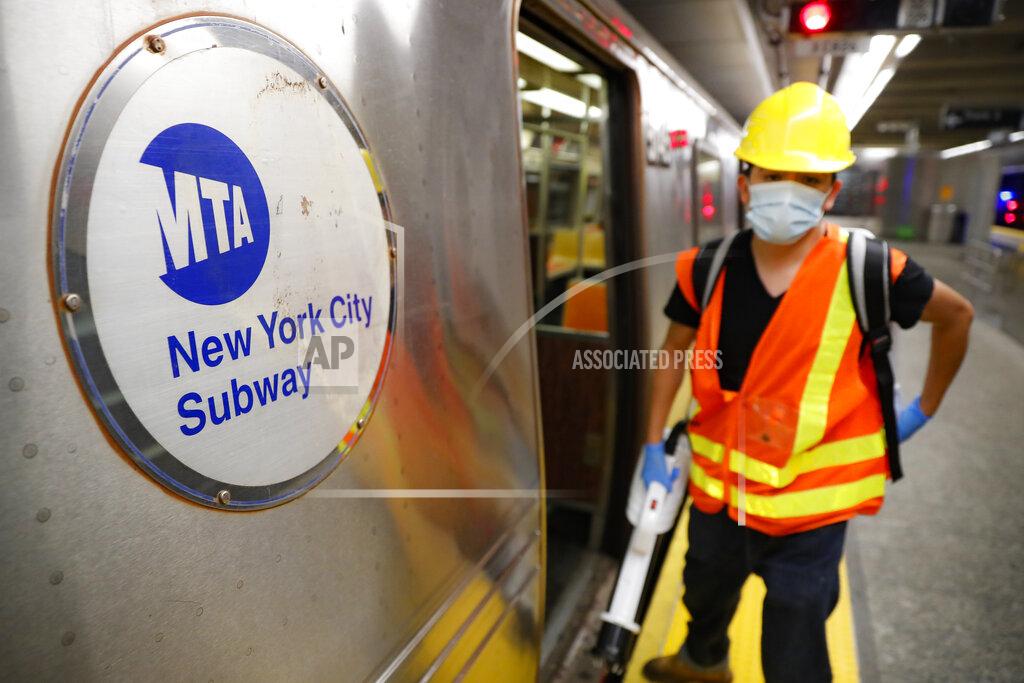 John Minchillo Contractors clean subway cars at the 96th Street station to control the spread of COVID-19, Thursday, July 2, 2020, in New York. Mass transit systems around the world have taken unprecedented — and expensive — steps to curb the spread of the coronavirus, including shutting down New York subways overnight and testing powerful ultraviolet lamps to disinfect seats, poles and floors. (AP Photo/John Minchillo)