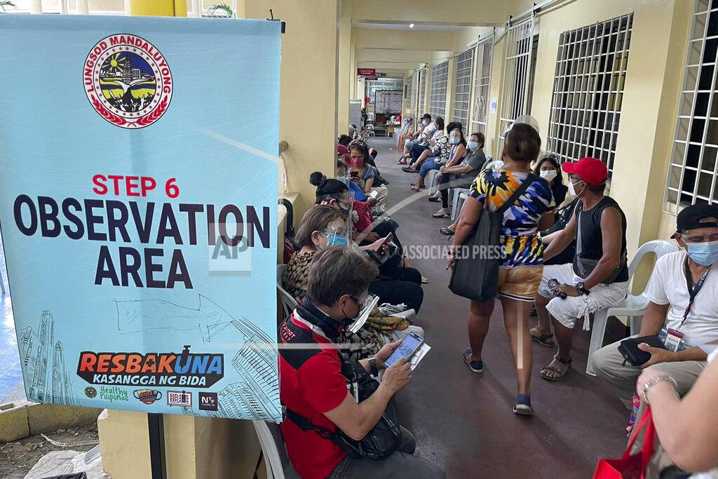 Joeal Calupitan Residents sit at an observation area after receiving their second dose of AstraZeneca COVID-19 vaccine in Mandaluyong city, Philippines Friday, July 23, 2021. Philippine officials said a local transmission of the highly contagious delta variant of the COVID-19 virus has been detected in the country and announced Friday tighter quarantine restrictions in the capital and a weeklong ban on the entry of travelers from hard-hit Malaysia and Thailand. (AP Photo/Joeal Calupitan)