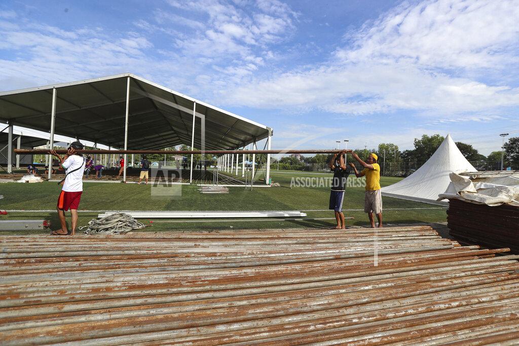 Thein Zaw Labors work to construct a temporary quarantine center for people infected or suspected of carrying the new coronavirus, at a football stadium, in Yangon, Myanmar Monday, Sept. 14, 2020. Authorities in Yangon, Myanmar’s biggest city, are expanding quarantine facilities as new cases of the coronavirus have risen to more than 100 a day. (AP Photo/Thein Zaw)