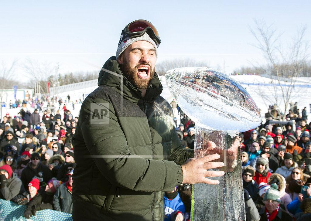 Graham Hughes Super Bowl champion and Kansas City Chiefs player Laurent Duvernay-Tardif reacts next to an ice sculpture of the Vince Lombardi Trophy during an event to celebrate his win, in Montreal, Sunday, Feb. 9, 2020. (Graham Hughes/The Canadian Press via AP)