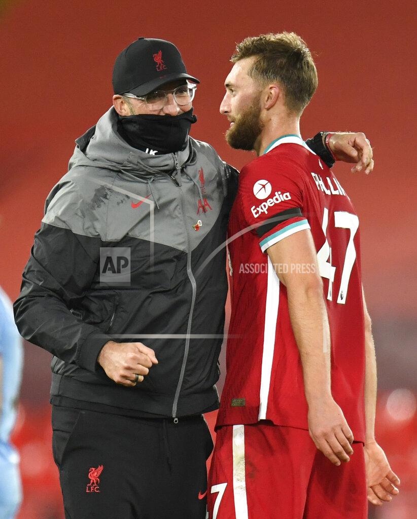 Peter Powell Liverpool's manager Jurgen Klopp hugs Liverpool's Nathaniel Phillips at the end of the English Premier League soccer match between Liverpool and West Ham United at Anfield stadium in Liverpool, England, Saturday, Oct. 31, 2020. (Peter Powell/Pool via AP)