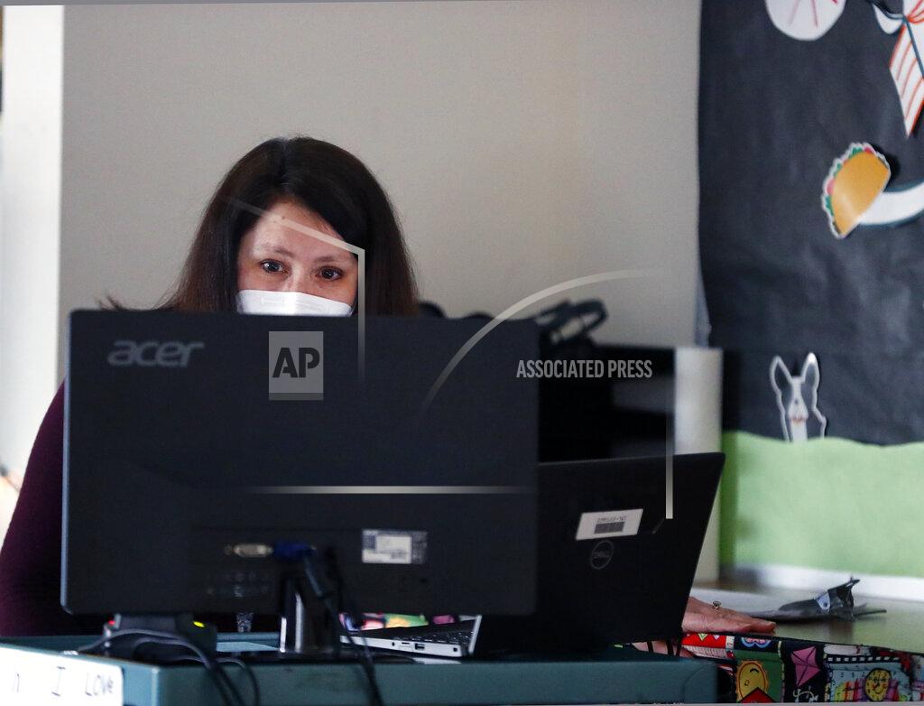 Brian Hill Emerson Elementary School librarian Lauren Blanford Wednesday Feb. 24, 2021 in Elmhurst, Ill. (Brian Hill/Daily Herald via AP)