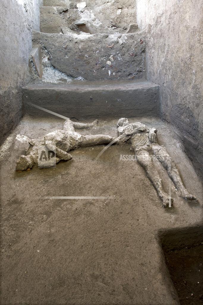 Uncredited The casts of what are believed to have been a rich man and his male slave fleeing the volcanic eruption of Vesuvius nearly 2,000 years ago, are seen in what was an elegant villa on the outskirts of the ancient Roman city of Pompeii destroyed by the eruption in 79 A.D., where they were discovered during recents excavations, Pompeii archaeological park officials said Saturday, Nov. 21, 2020. (Parco Archeologico di Pompei via AP)