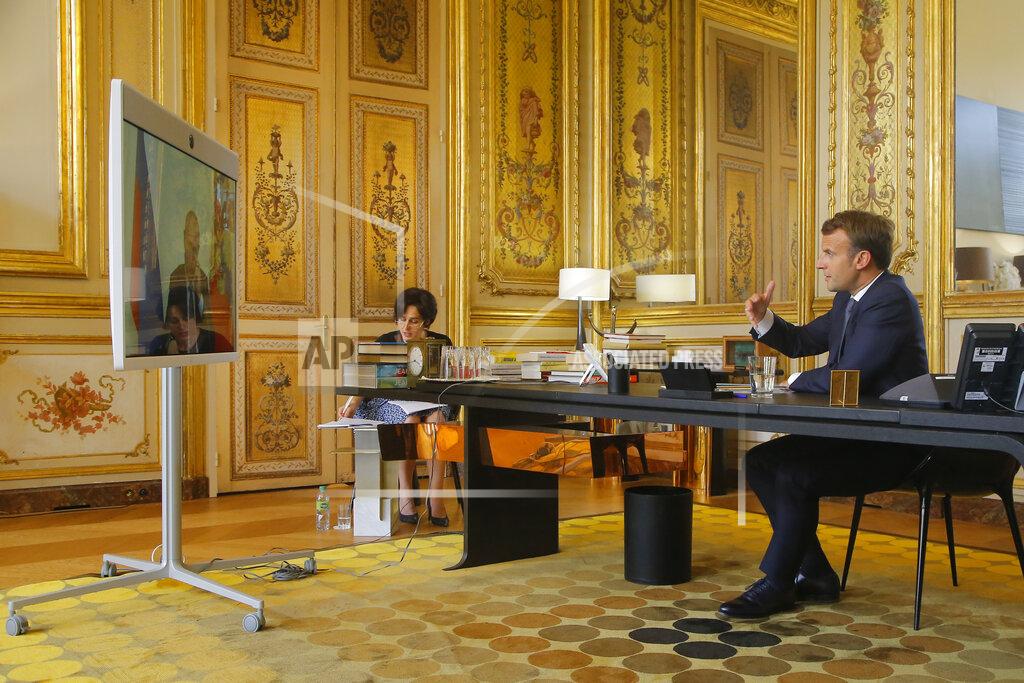 French President Emmanuel Macron talks to Russian President Vladimir Putin during a video conference Friday, June 26, 2020 at the Elysee Palace in Paris. Russian President Vladimir Putin holds video talks with French President Emmanuel Macron about the virus, Libya, Syria and relations with the U.S. under Donald Trump. (AP Photo/Michel Euler, Pool)