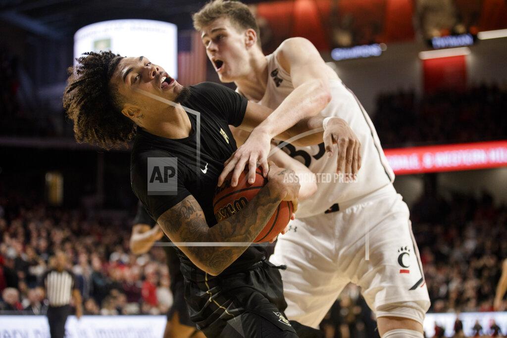 Albert Cesare Central Florida guard Brandon Mahan (13) is fouled by Cincinnati center Chris Vogt (33) in overtime of an NCAA college basketball game Wednesday, Feb. 19, 2020, in Cincinnati. (Albert Cesare/The Cincinnati Enquirer via AP)