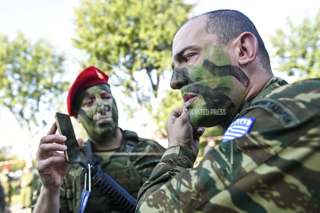 Giannis Papanikos Officers from the Greek military special forces prepare for a parade at the northern port city of Thessaloniki, Greece, Thursday, Oct. 28, 2021 .The parade is held to celebrate Greece's refusal to align itself with a belligerent fascist Italy in 1940 and instead fight a much stronger opponent, a decision which dragged it into World War II and eventually led to a brutal occupation by Nazi Germany. (AP Photo/Giannis Papanikos)