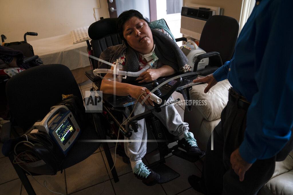 Jae C. Hong A blood oxygen monitor is attached to Socorro Franco-Martinez, who has muscular dystrophy, after she received the second dose of the Pfizer COVID-19 vaccine at her apartment, Wednesday, May 12, 2021, in Torrance, Calif. Teamed up with the Torrance Fire Department, Torrance Memorial Medical Center started inoculating people at home in March, identifying people through a city hotline, county health department, senior centers and doctor's offices, said Mei Tsai, the pharmacist who coordinates the program. (AP Photo/Jae C. Hong)