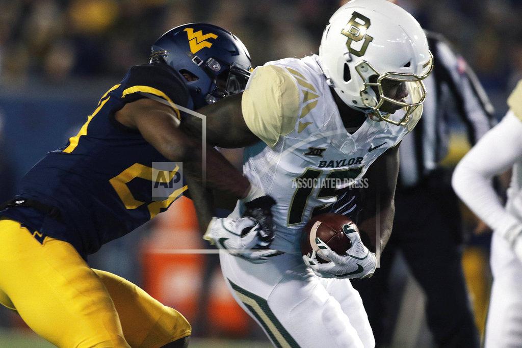 Ray Thompson Baylor wide receiver Denzel Mims (15) is tackled by West Virginia cornerback Hakeem Bailey (24) during the second half of an NCAA college football game, Thursday, Oct. 25, 2018, in Morgantown, W.Va. (AP Photo/Raymond Thompson)