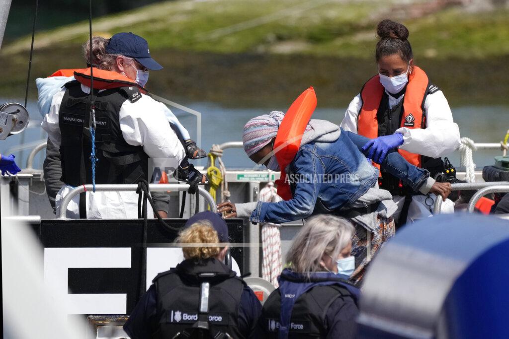 Matt Dunham A woman and a child thought to be migrants are disembarked from a British border force vessel in Dover, south east England, Thursday, July 22, 2021. The number of undocumented migrants reaching Britain in small boats this year has surpassed the total for all of 2020, as people smugglers take advantage of good weather to cross the English Channel from France. (AP Photo/Matt Dunham)