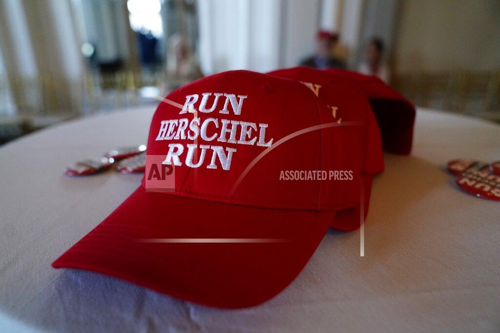Brynn Anderson A hat supporting U.S. Senate candidate Herschel Walker lies on a table during an election night watch party, Tuesday, May 24, 2022, in Atlanta. (AP Photo/Brynn Anderson)