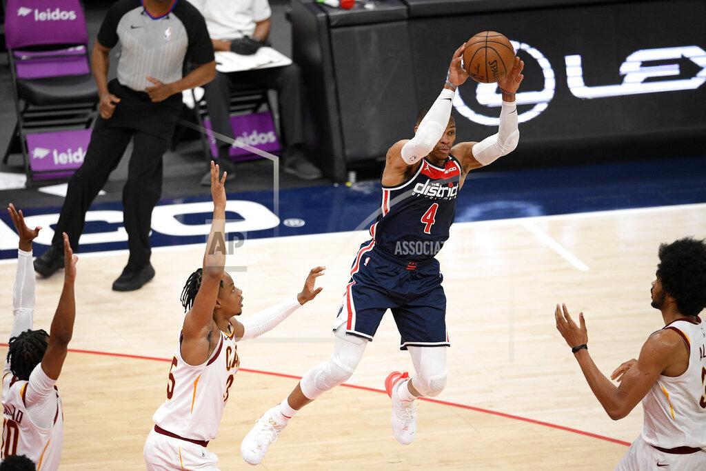 Nick Wass Washington Wizards guard Russell Westbrook (4) leaps up to pass the ball from between Cleveland Cavaliers center Jarrett Allen, right, forward Isaac Okoro, second from left, and guard Darius Garland, left, during the first half of an NBA basketball game Friday, May 14, 2021, in Washington. (AP Photo/Nick Wass)