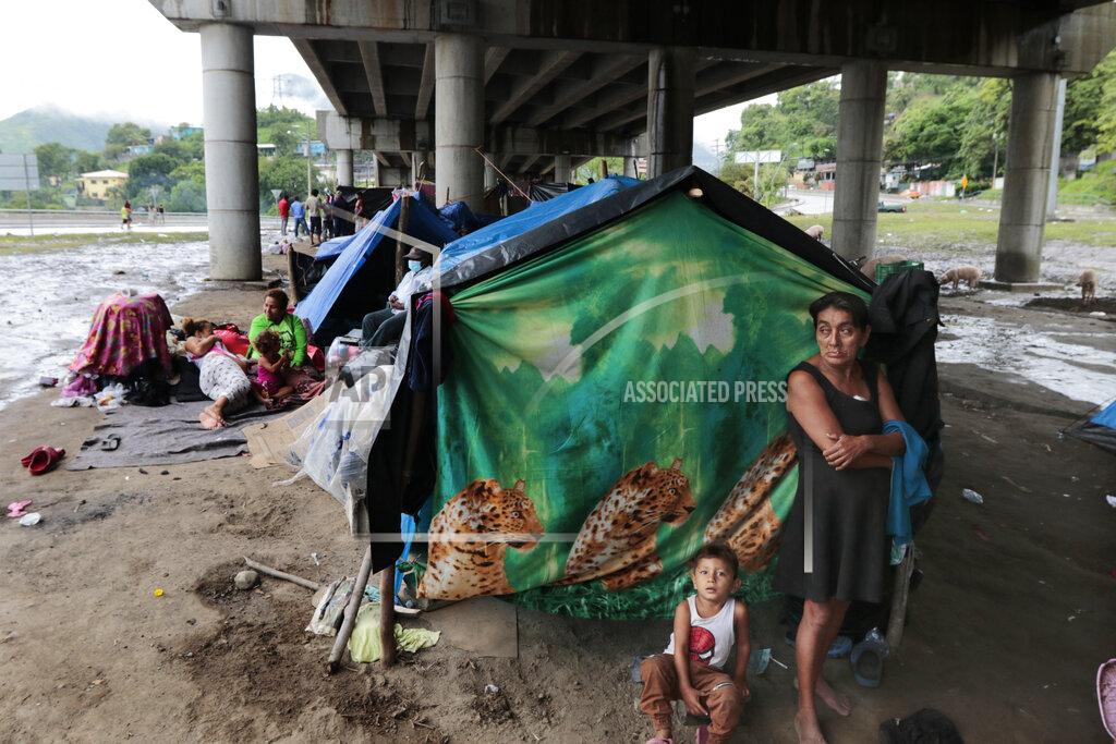Delmer Martinez Hurricane victims take refuge under a bridge in San Pedro Sula, Honduras, Saturday, Nov. 21, 2020. Shelters for people whose homes were flooded or damaged by hurricanes Eta and Iota in Honduras are now so crowded that thousands of victims have taken refuge under highway overpasses or bridges. The Red Cross estimates that about 4.2 million people were affected by the back-to-back hurricanes in November in Honduras, Nicaragua and Guatemala. (AP Photo/Delmer Martinez)
