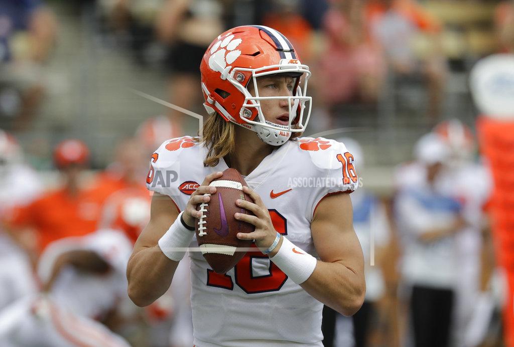 Chuck Burton FILE - In this Oct 6, 2018 file photo, Clemson's Trevor Lawrence (16) looks to pass against Wake Forest during the first half of an NCAA college football game in Charlotte, N.C. Lawrence has quickly found his place on the second-ranked Tigers latest championship run. Lawrence has thrown for 300 yards in his past two games, both statement wins against formerly undefeated North Carolina State and at rival Florida State the past two weeks. (AP Photo/Chuck Burton, File)