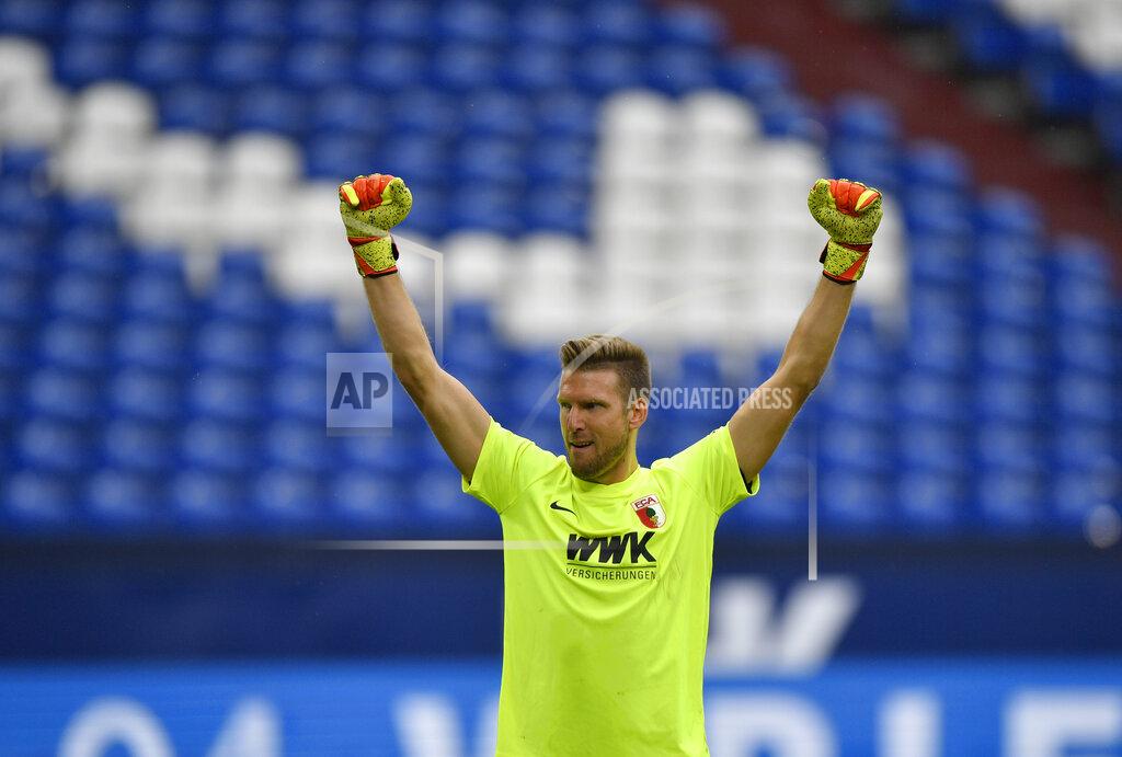 Martin Meissner Augsburg's goalkeeper Andrea Luthe celebrates after Augsburg's Sergio Cordova scoring his side's third goal during the German Bundesliga soccer match between FC Schalke 04 and FC Augsburg at the Veltins-Arena in Gelsenkirchen, Germany, Sunday, May 24, 2020. The German Bundesliga becomes the world's first major soccer league to resume after a two-month suspension because of the coronavirus pandemic. (AP Photo/Martin Meissner, Pool)