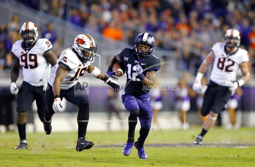 Tom Fox TCU wide receiver Derius Davis (12) breaks away for a long pass reception during the second quarter against Oklahoma State in an NCAA college football game in Fort Worth, Texas, Saturday, Nov. 24, 2018. (Tom Fox/The Dallas Morning News via AP)
