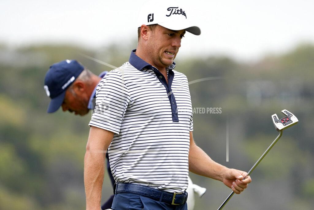 David J. Phillip Justin Thomas reacts after missing his birdie putt on the 14th hole, in his match against Matt Kuchar, left, during a first round match at the Dell Technologies Match Play Championship golf tournament Wednesday, March 24, 2021, in Austin, Texas. (AP Photo/David J. Phillip)
