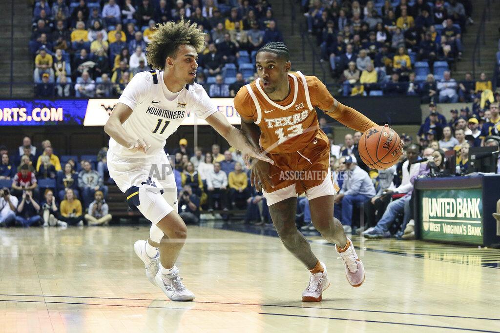 Kathleen Batten Texas guard Jase Febres (13) drives it up court as he is defended by West Virginia forward Derek Culver (1) during the first half of an NCAA college basketball game Monday, Jan. 20, 2020, in Morgantown, W.Va. (AP Photo/Kathleen Batten)
