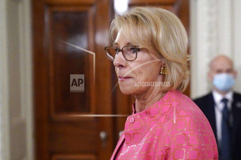 FILE - In this Aug. 12, 2020, file photo Education Secretary Betsy DeVos arrives for an event in the State Dining room of the White House in Washington. As millions of American children start the school year online, the Trump administration is hoping to convert their parents’ frustration and anger into newfound support for school choice policies that DeVos has long championed but struggled to advance nationally.(AP Photo/Andrew Harnik, File)