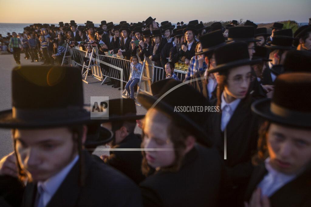 Ariel Schalit Ultra-Orthodox Jews of the Kiryat Sanz Hassidic sect listen to their rabbi on a hill overlooking the Mediterranean Sea as they participate in a Tashlich ceremony, in Netanya, Israel, Tuesday, Sept. 14, 2021. Tashlich, which means "to cast away" in Hebrew, is the practice in which Jews go to a large flowing body of water and symbolically "throw away" their sins by throwing a piece of bread, or similar food, into the water before the Jewish holiday of Yom Kippur, which starts at sundown on Wednesday. (AP Photo/Ariel Schalit)