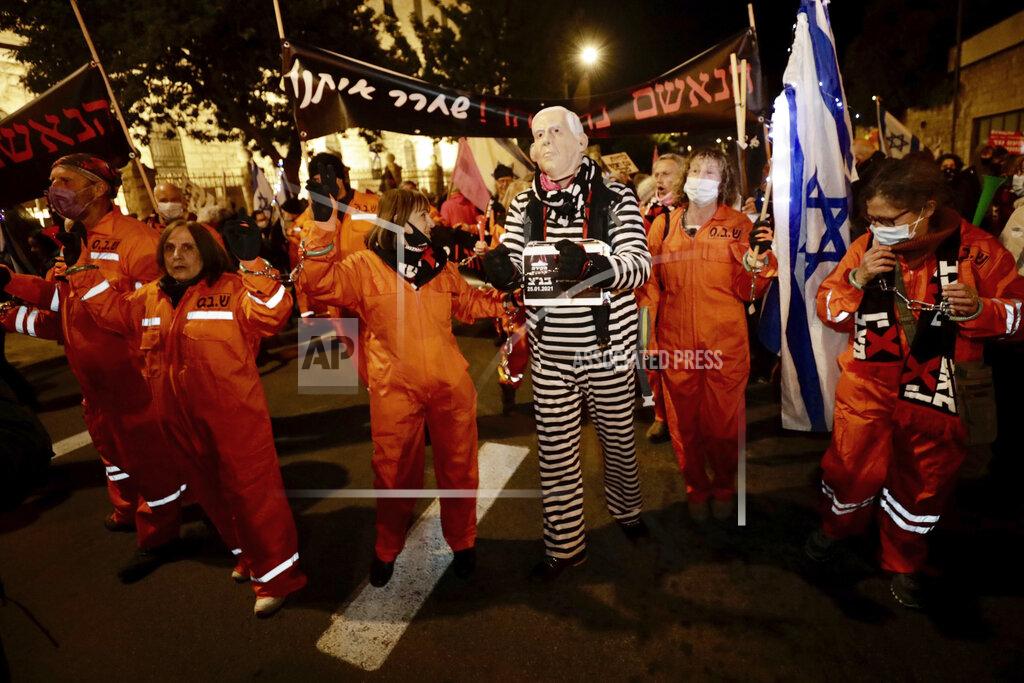 Sebastian Scheiner Israeli protesters chant slogans during a demonstration against Israeli Prime Minister Benjamin Netanyahu In Jerusalem, Saturday, Jan. 23, 2021. (AP Photo/Sebastian Scheiner)