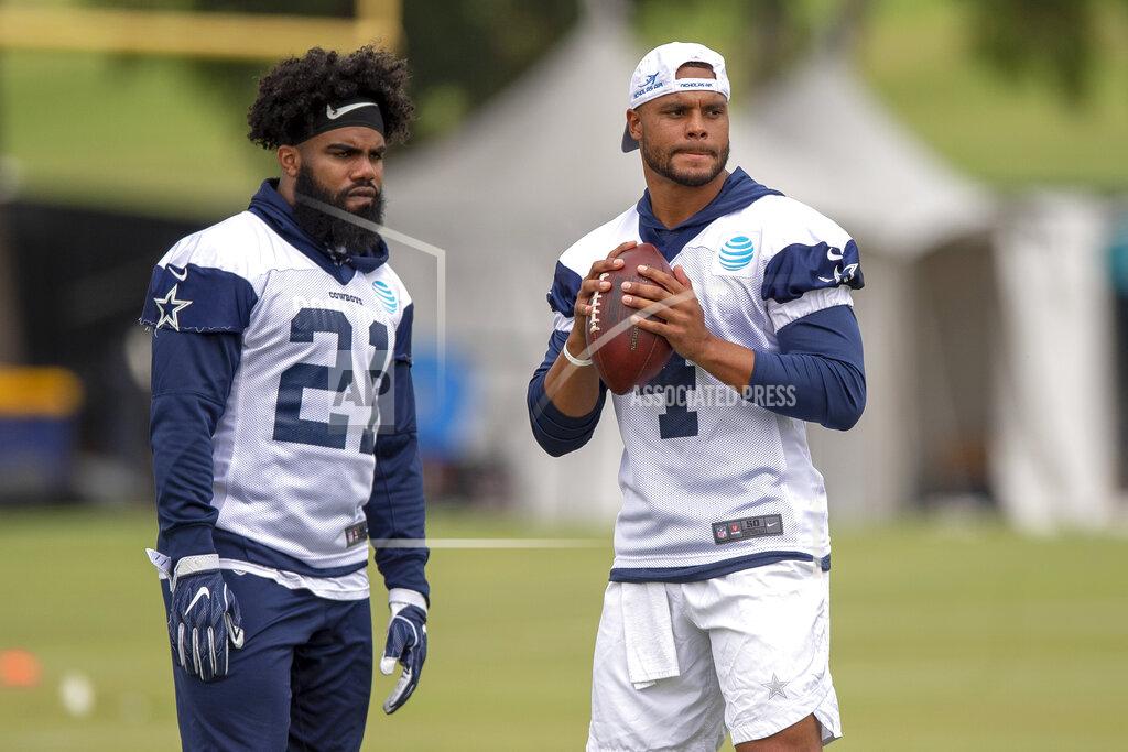 Gus Ruelas FILE - In this July 26, 2018, file photo, Dallas Cowboys running back Ezekiel Elliott (21) and quarterback Dak Prescott (4) run plays during Dallas Cowboys' NFL training camp, in Oxnard, Calif. Prescott has his backfield mate back now that Ezekiel Elliott's holdout is over. (AP Photo/Gus Ruelas, File)