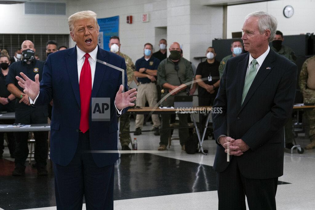 FILE - In this Sept. 1, 2020 file photo, President Donald Trump speaks in Kenosha, Wis., as Sen. Ron Johnson, R-Wis., right, listens. Sen. Johnson said Monday, Sept. 14, 2020, that President Donald Trump deserves to win more than one Nobel Peace Prize for his "leadership" and "brilliant negotiating strategy" in foreign diplomacy and reaching peace agreements. (AP Photo/Evan Vucci File)