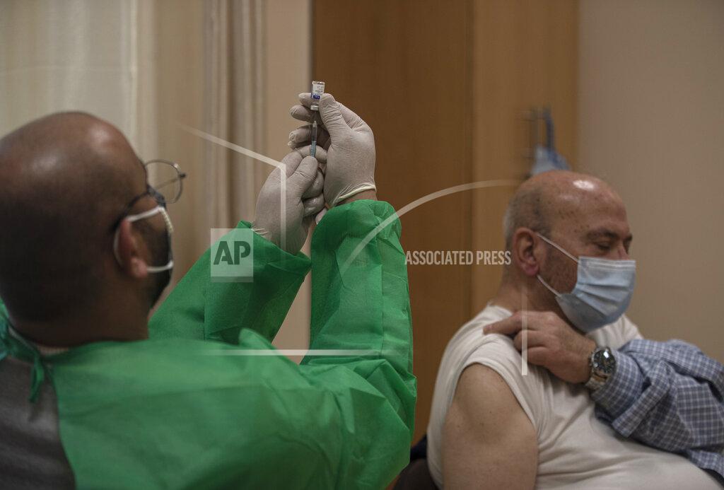 Khalil Hamra A Palestinian medic prepares to give a shot of the Russian-made Sputnik V coronavirus vaccine, at an UNRWA clinic in Gaza City, Wednesday, March 17, 2021. The Palestinian Authority says it will receive 62,000 coronavirus vaccine doses through a World Health Organization partnership designed to help poor countries. (AP Photo/Khalil Hamra)