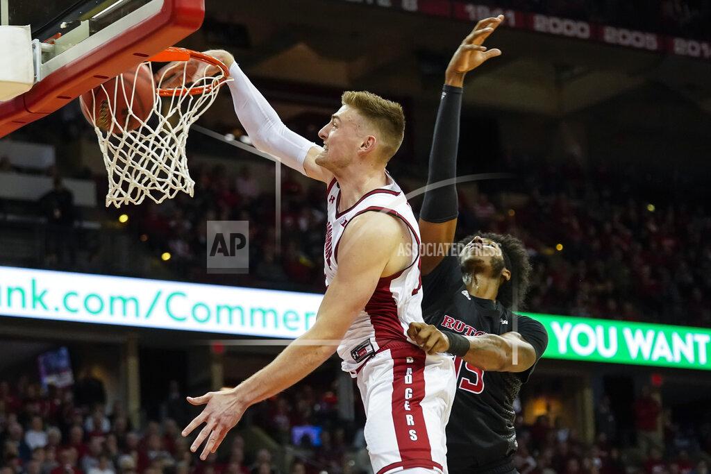 Andy Manis Wisconsin's Micah Potter, left, dunks past Rutgers' Myles Johnson (15) during the second half of an NCAA college basketball game Sunday, Feb. 23, 2020, in Madison, Wis. (AP Photo/Andy Manis)