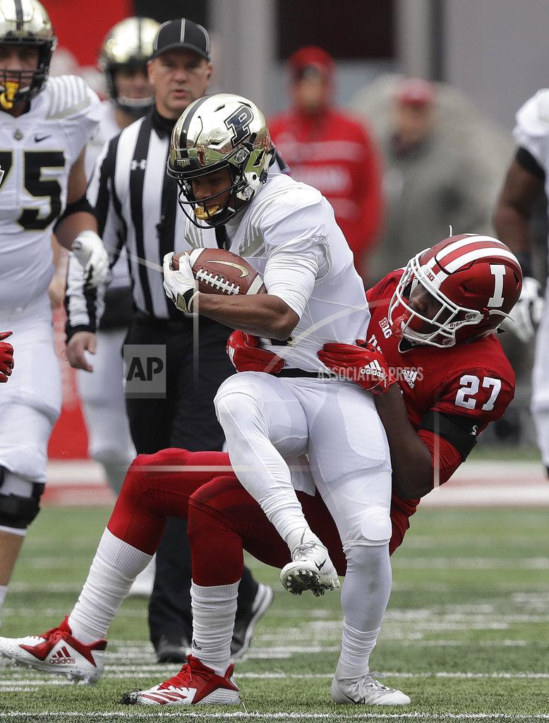 Darron Cummings Purdue's Rondale Moore (4) is tackled by Indiana's Devon Matthews (27) during the first half of an NCAA college football game, Saturday, Nov. 24, 2018, in Bloomington, Ind. (AP Photo/Darron Cummings)